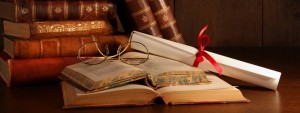 cropped-libros-antiguos-apilados-lentes-y-pergamino-sobre-libro-abierto